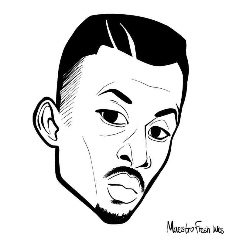 A man with a medium sized goatee on his face and a two line design shaved into the front of his hairline to create a Hip Hop hairstyle.