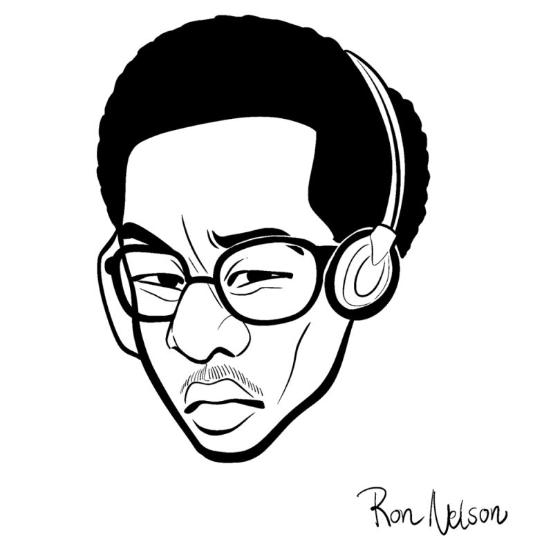  A man with quizzical face, a small-sized afro hairstyle, round and black rimmed glasses, and large headphones over his ears.