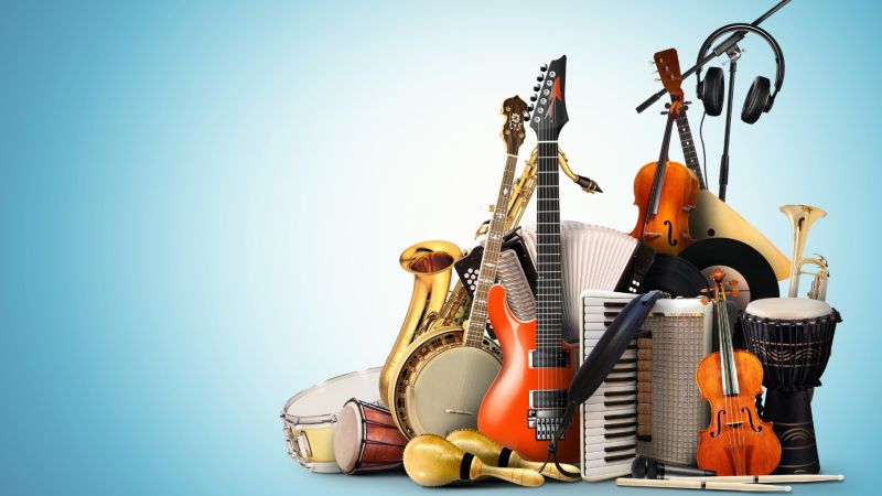 A collection of acoustic musical instruments and equipment arranged together against a blue background.
