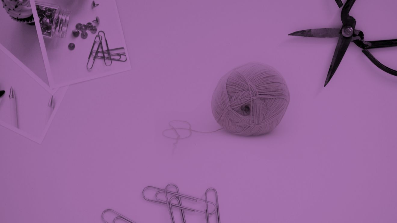 An image of various craft tools and materials with a purple filter. 