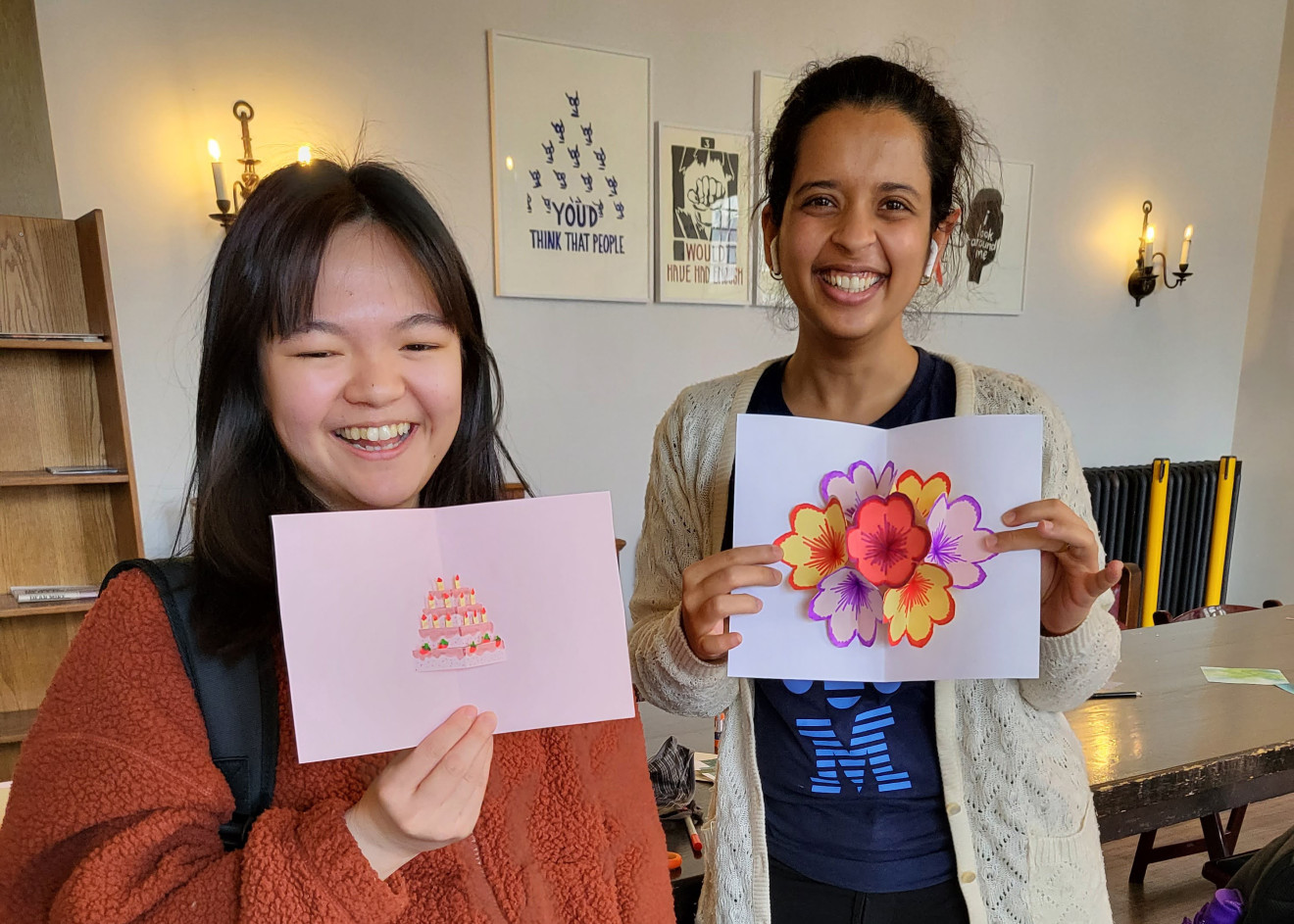 Two U of T students posing with their handmade greeting cards. 