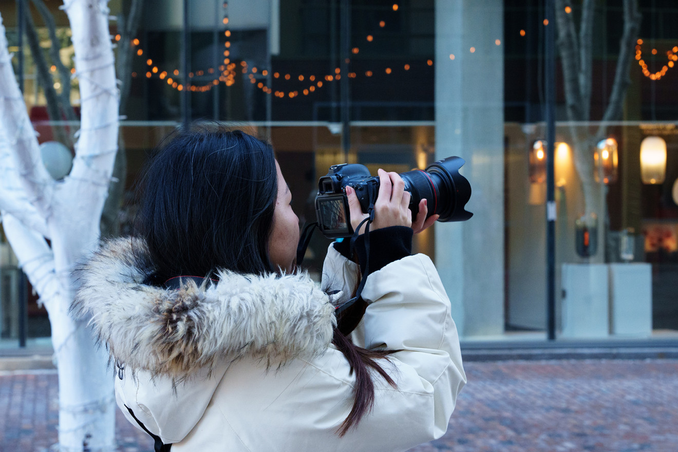 A person doing outdoor city photography on a winter day.