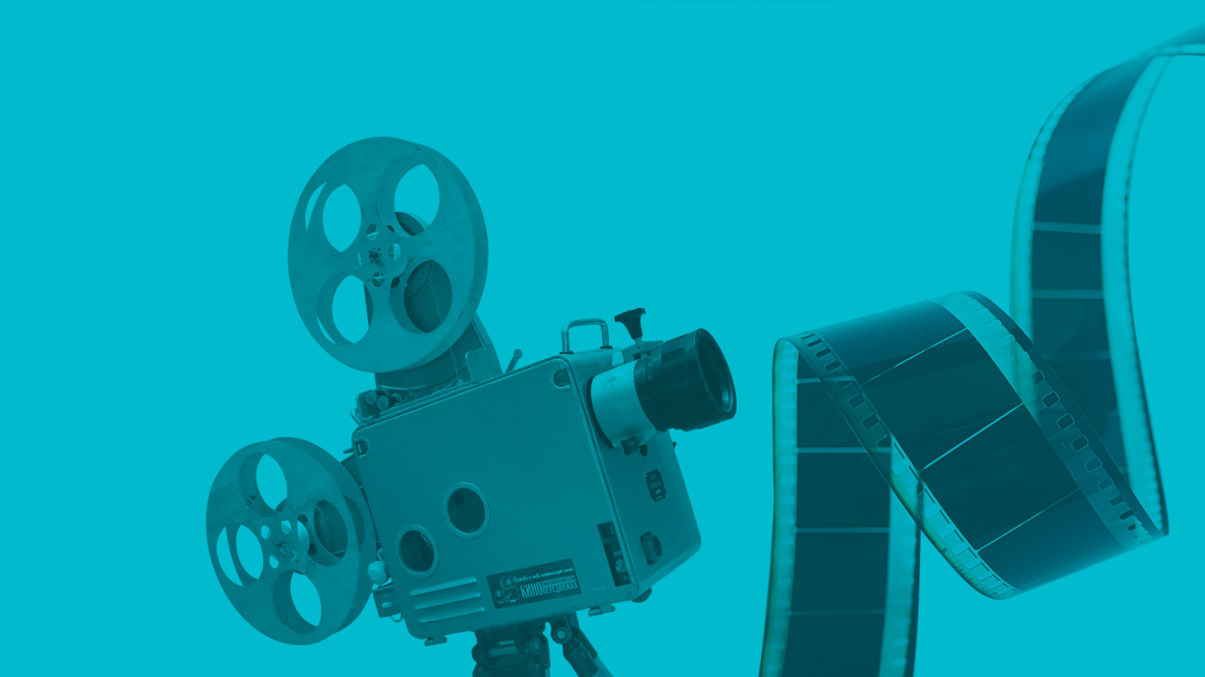 Blue background with a photo of a reel-to-reel projector and a strip of negative film.