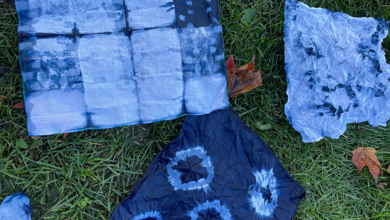 photo of tie-dyed clothes and garments on the grass.