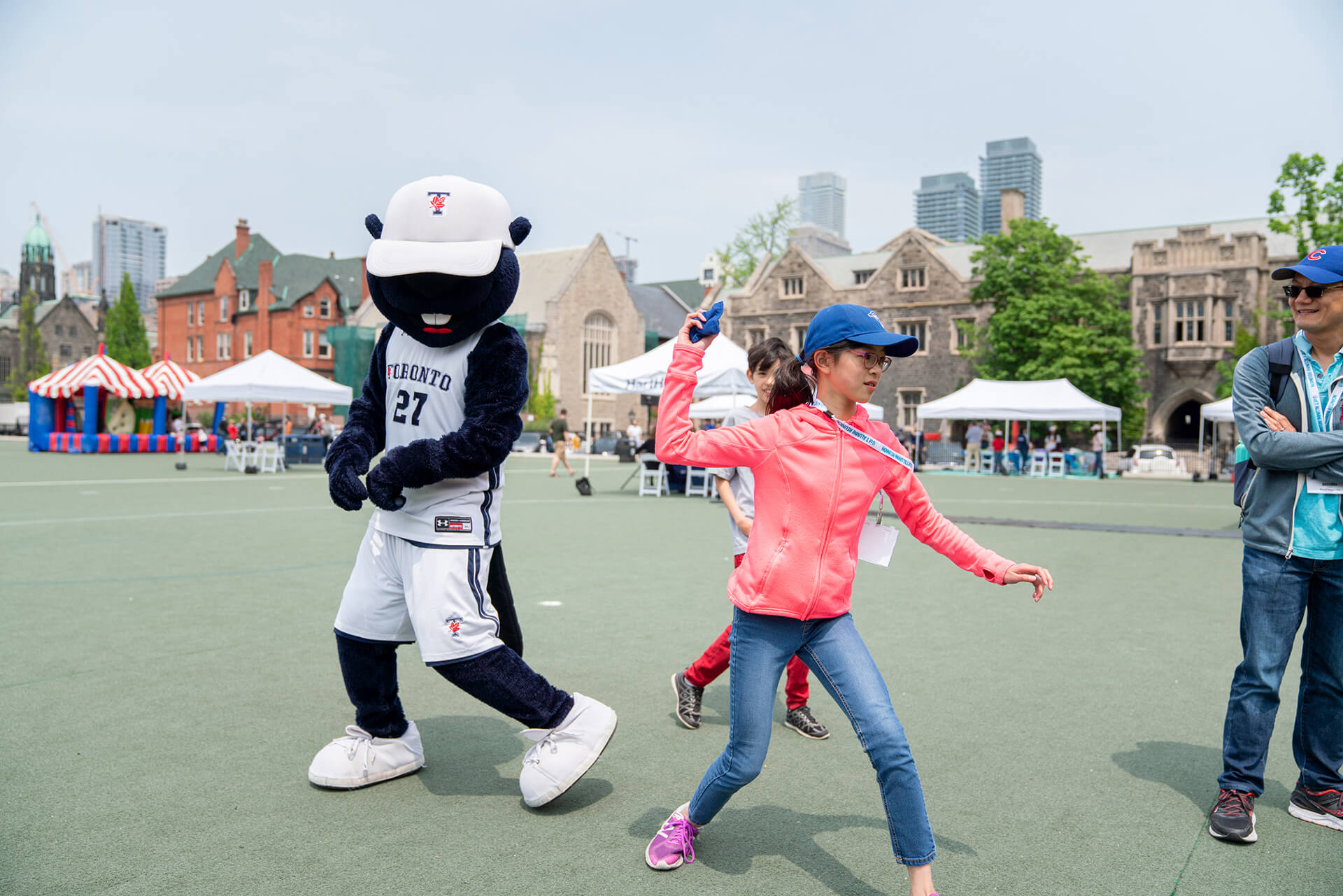 kids hang out with U of T’s mascot True Blue on the play court