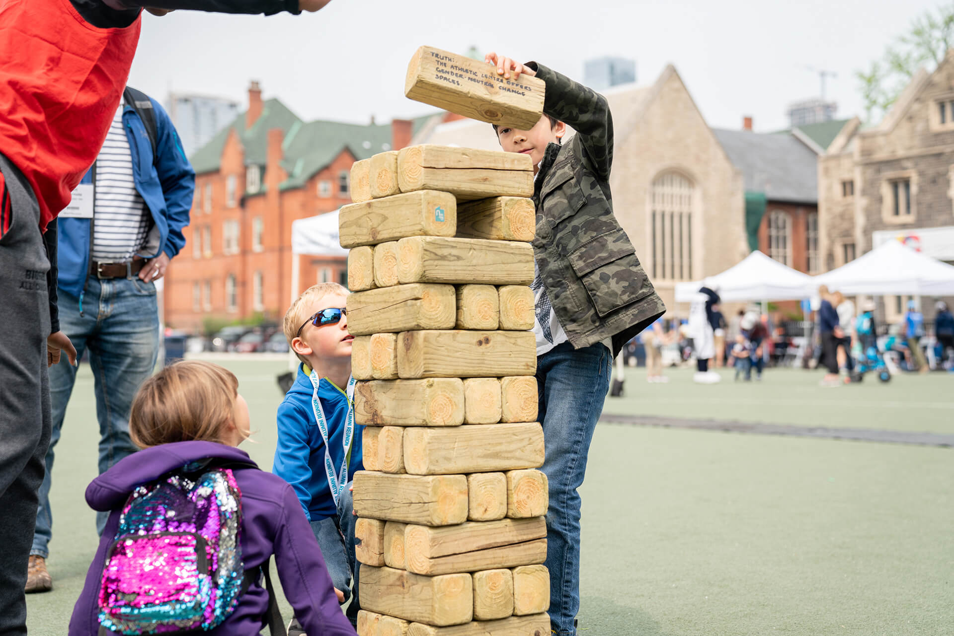 kids playing with the giant Jenga on a large play court