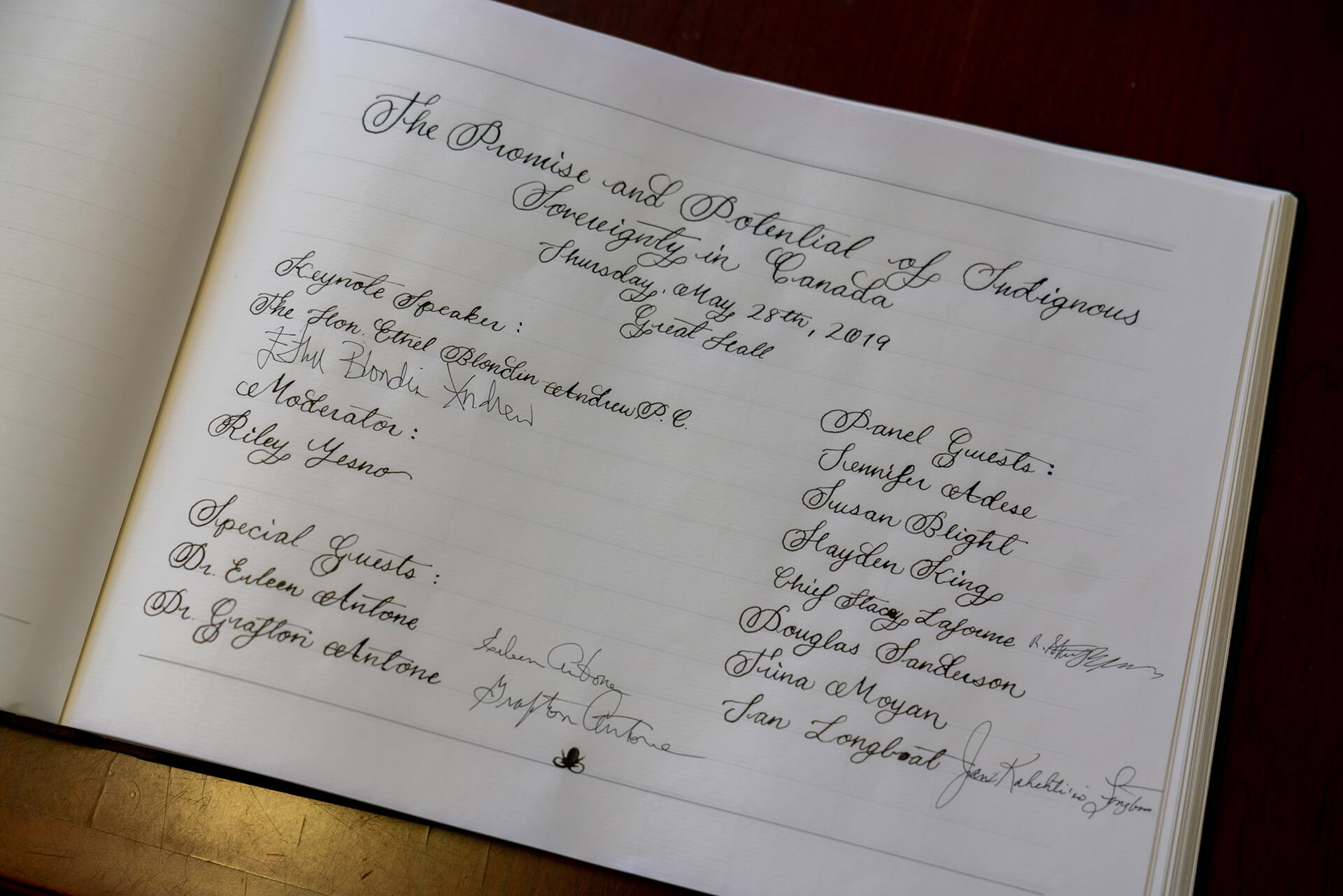 first page spread of the guest book with handwritten event's details 