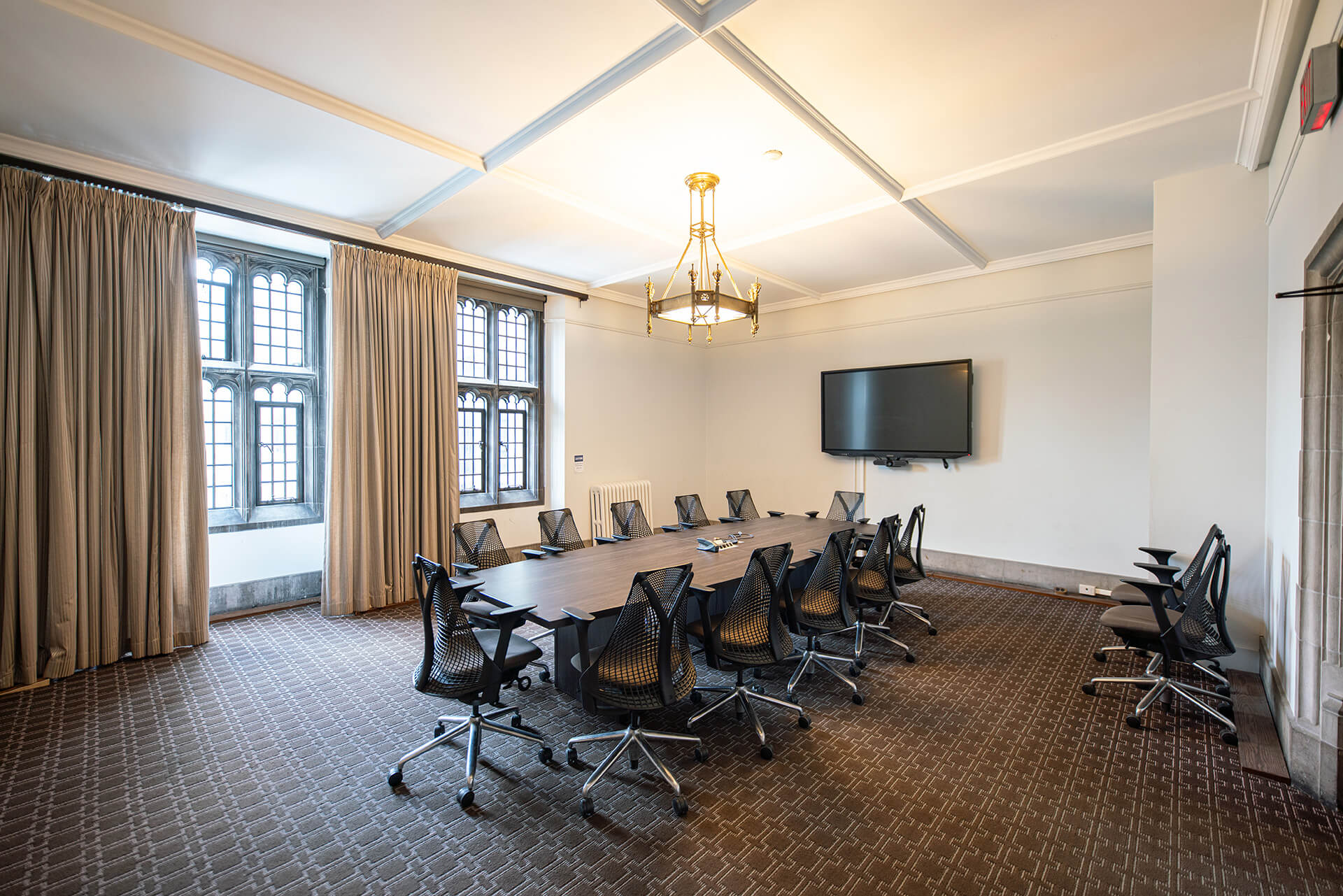 A large board table, comfortable chairs and a flatscreen with video conference capabilities.