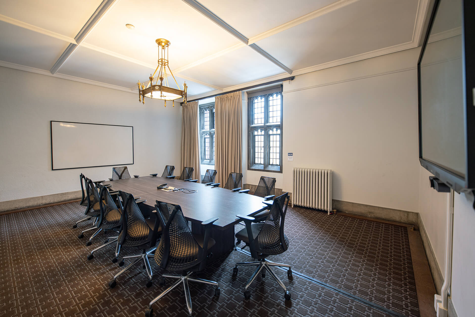 A large board table, comfortable chairs and a flatscreen with video conference capabilities.