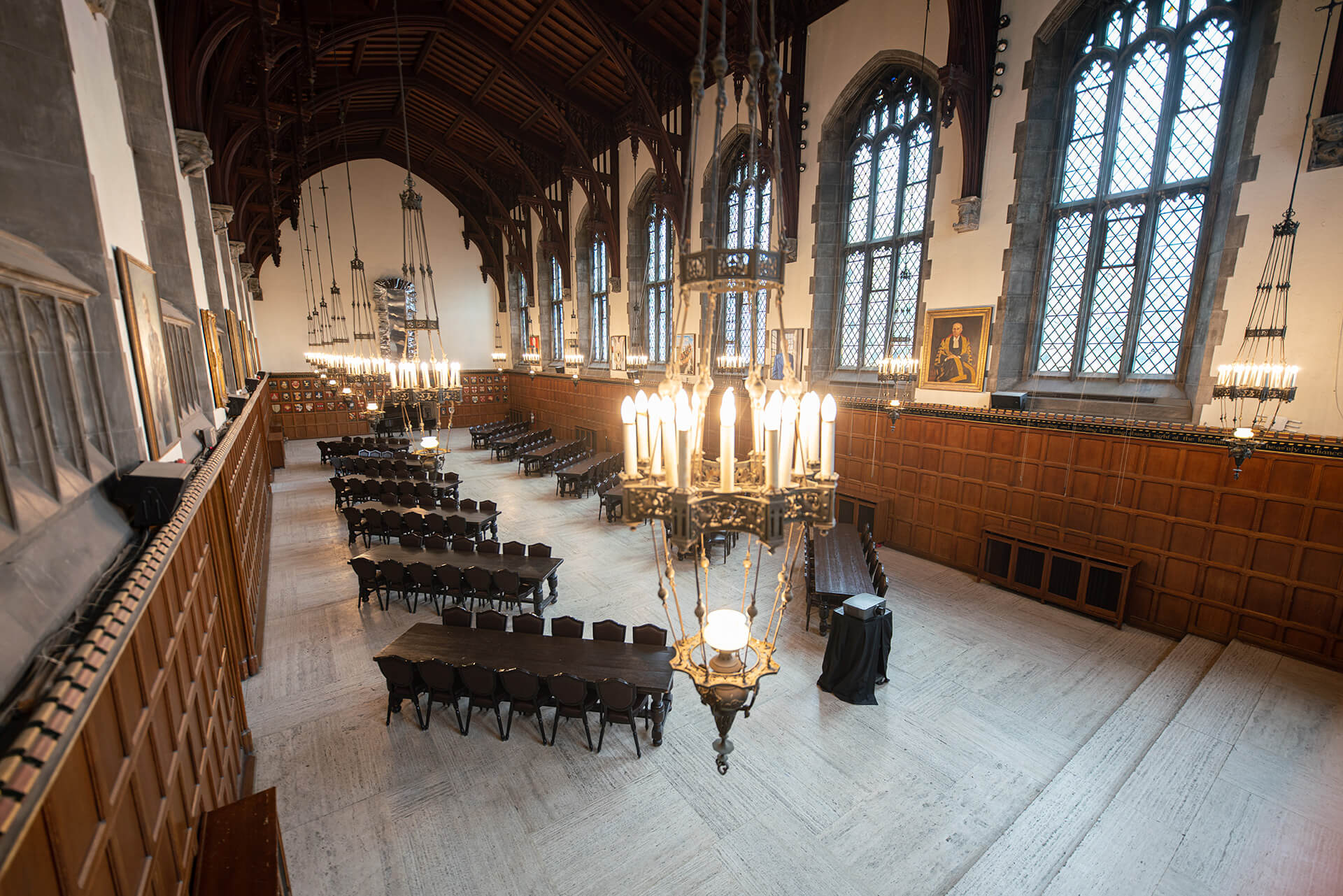 A view of the Great Hall from overhead, with bare, wooden tables