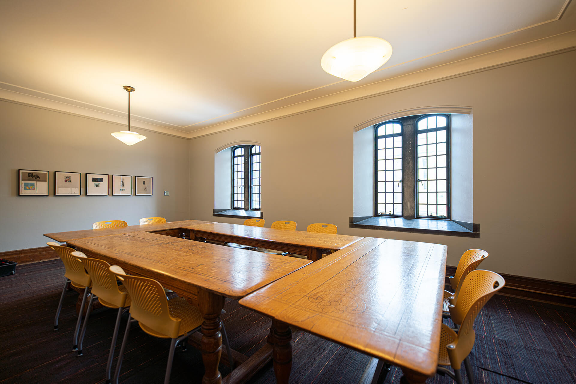 A board table with gothic windows in a bright room