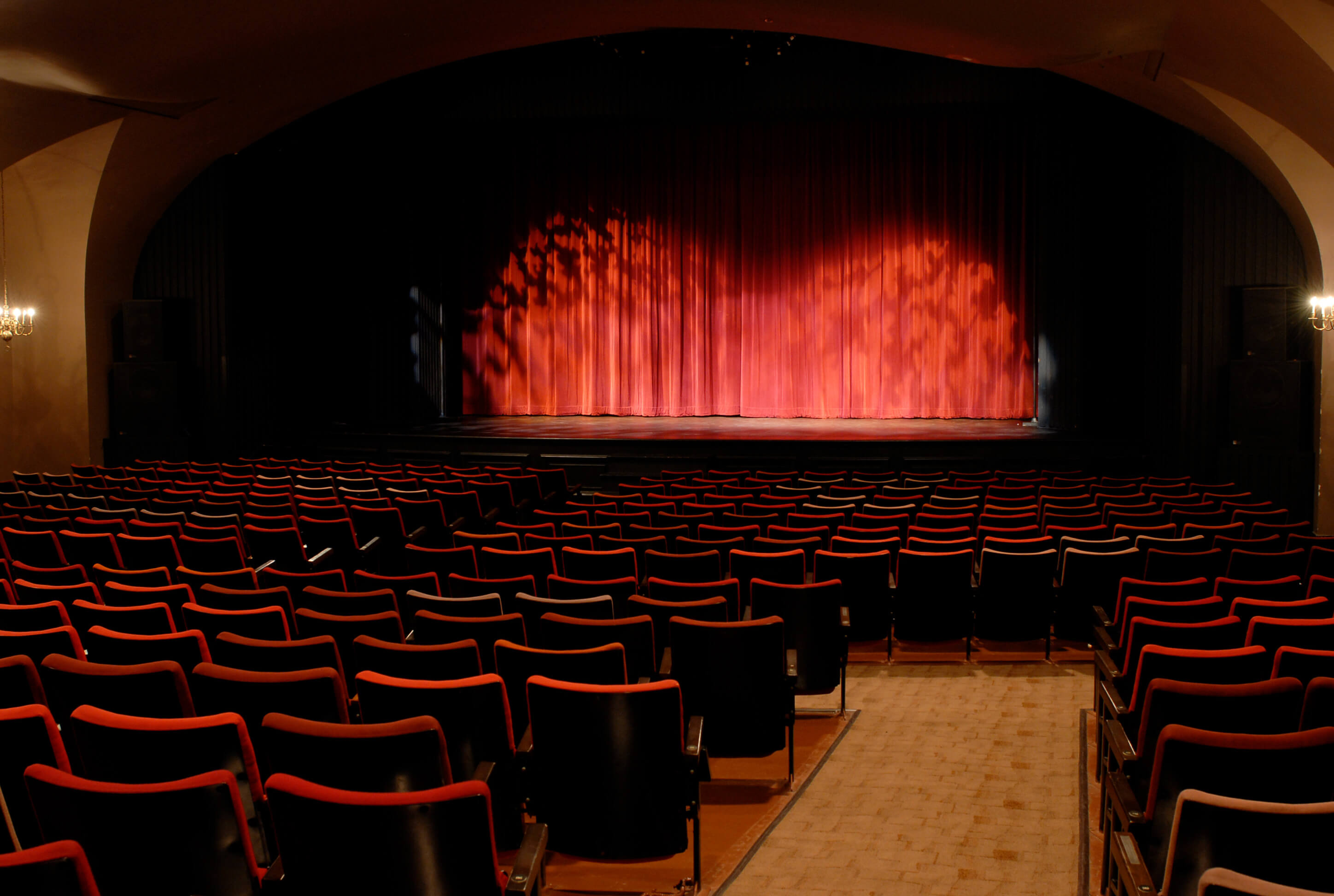 Spotlights on the stage, with seating in the auditorium